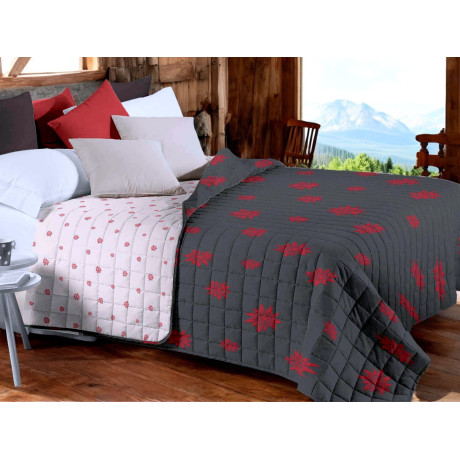 Grey Edelweiss quilted bedspread with red décor on rustic bed